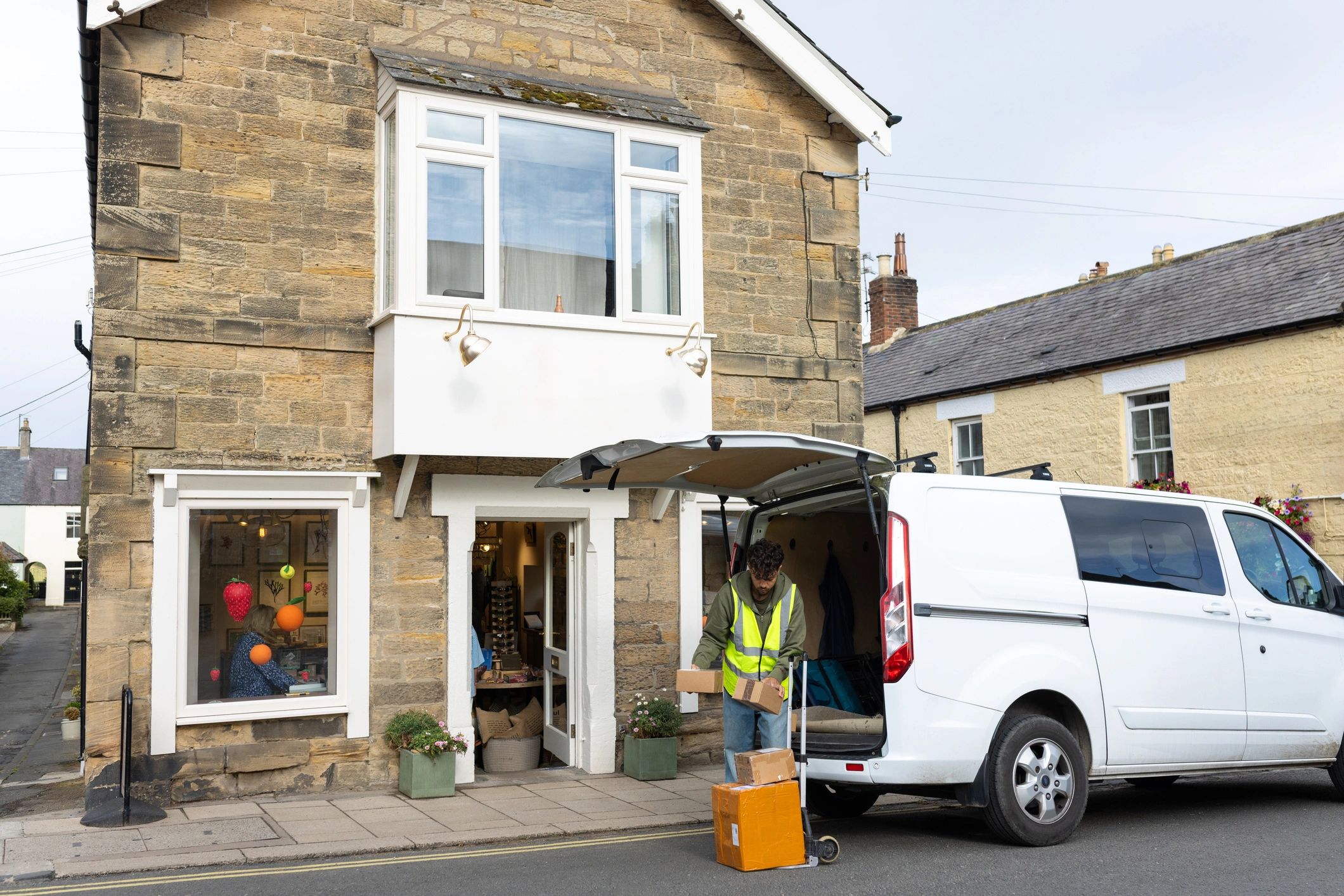 Delivery driver with parcels on a trolley