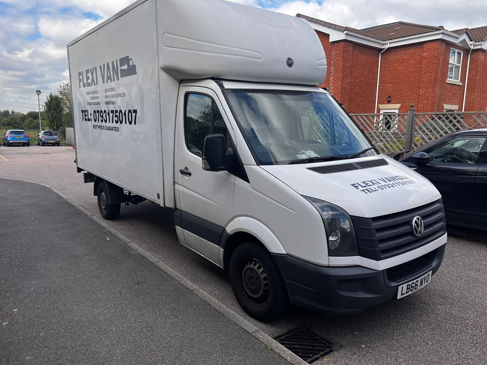 FLEXI VAN removals truck parked on a residential street, front side view