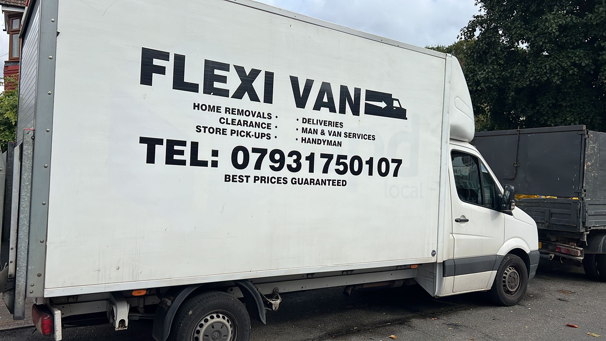 Side view of FLEXI VAN removals truck with service branding