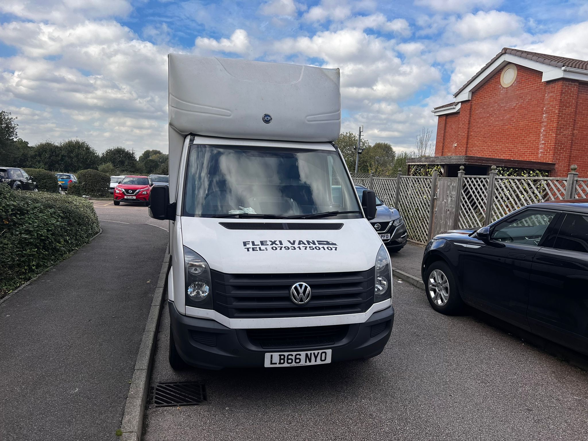 FLEXI VAN removals truck parked on a residential street, front view